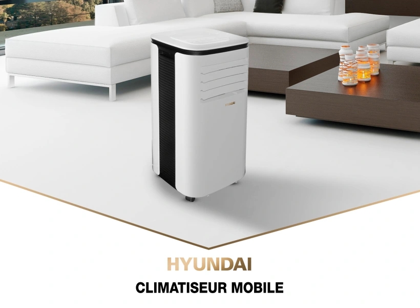 HYUNDAI Climatiseur mobile 9000 BTU dna sun salon à côté d'une table basse et d'un canapé